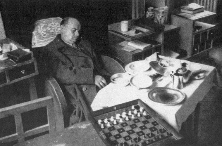 Alexander Alekhine siting while playing a chess. - Reprint